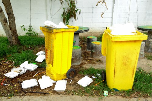 Business professionals handling waste in an office environment